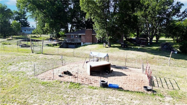 view of yard with fence and an outdoor structure