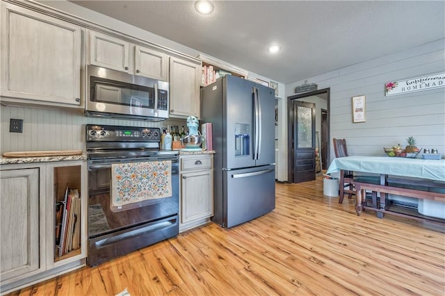 kitchen featuring light countertops, recessed lighting, light wood-style floors, and appliances with stainless steel finishes