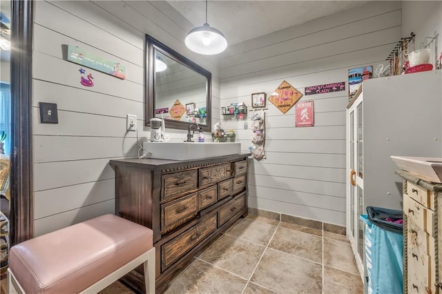 bathroom with wood walls and vanity