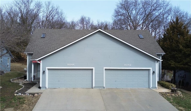 exterior space featuring concrete driveway, an attached garage, and roof with shingles