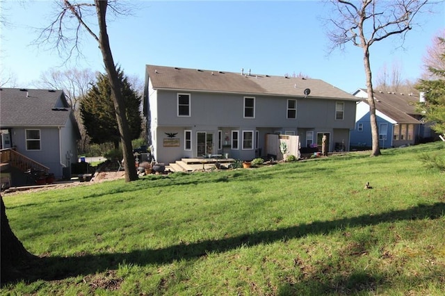 rear view of property featuring a lawn