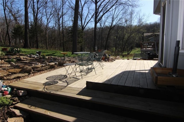 wooden terrace featuring outdoor dining space