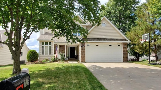 view of front of property with a front lawn, brick siding, and driveway