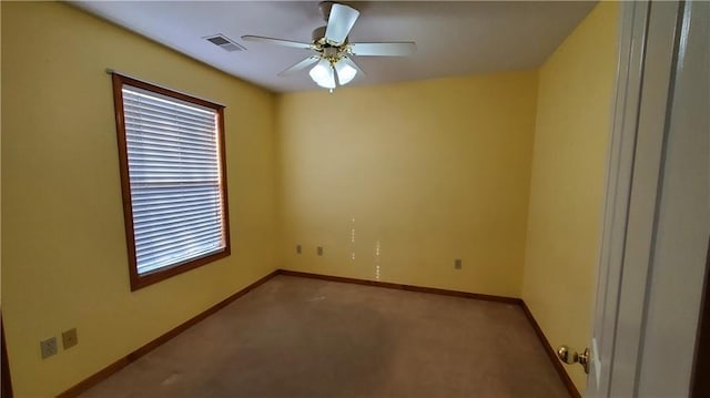 unfurnished room with visible vents, baseboards, carpet floors, and ceiling fan