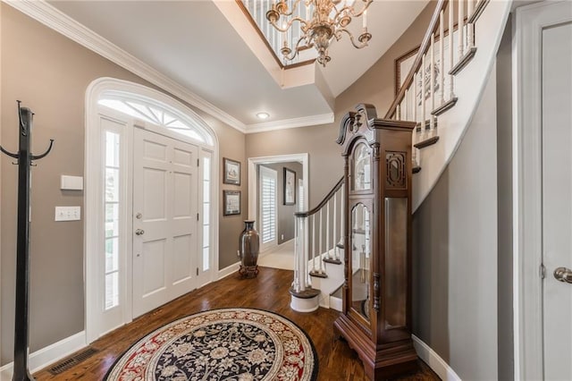 foyer with dark wood-type flooring, stairway, baseboards, and a wealth of natural light