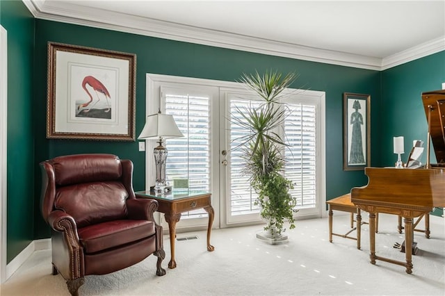 living area with carpet flooring, visible vents, and crown molding