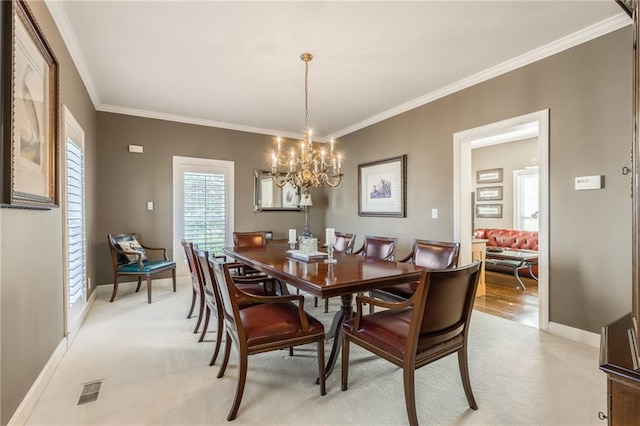 dining area featuring light colored carpet, baseboards, visible vents, and ornamental molding