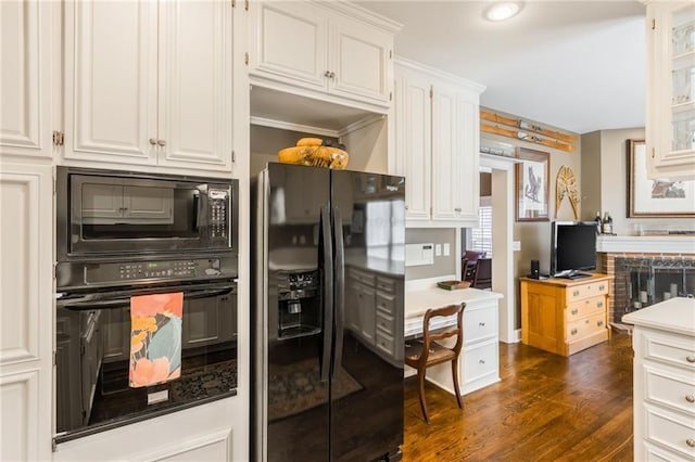 kitchen featuring black appliances, white cabinets, and dark wood-style flooring