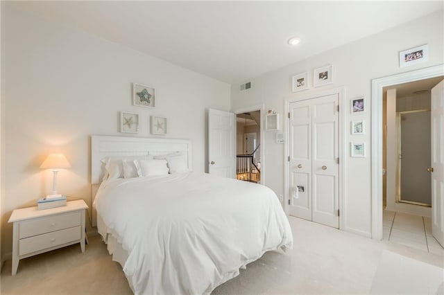 bedroom with light colored carpet and a closet