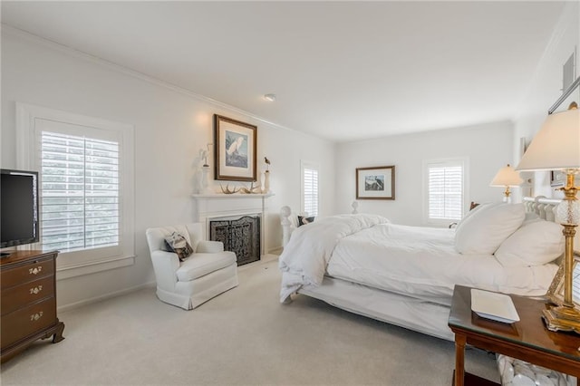 bedroom featuring a fireplace, light colored carpet, baseboards, and ornamental molding