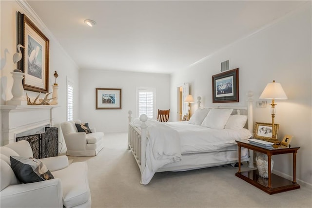 bedroom featuring a fireplace, light colored carpet, visible vents, and ornamental molding