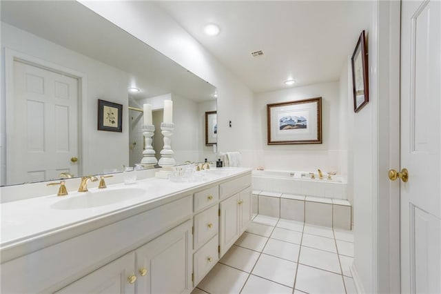 bathroom with a sink, a garden tub, double vanity, and tile patterned floors