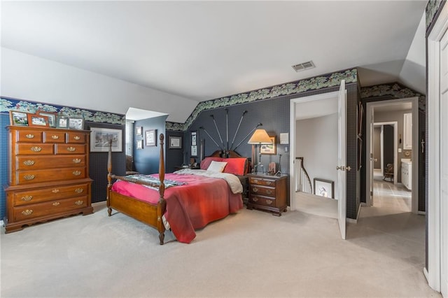 bedroom featuring wallpapered walls, lofted ceiling, carpet, and visible vents