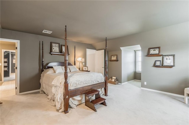 bedroom with light carpet, visible vents, and baseboards