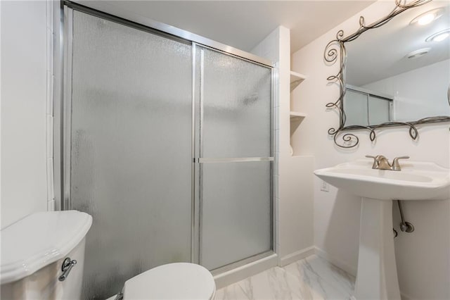 bathroom with baseboards, toilet, marble finish floor, and a stall shower