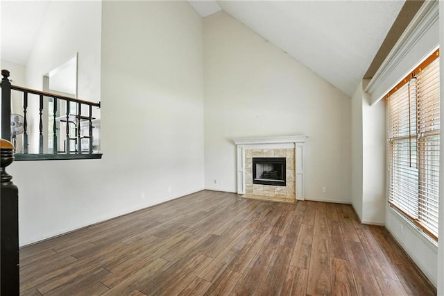 906 N Cedarcrest Dr, Olathe, KS 66061 - unfurnished living room with wood finished floors, high vaulted ceiling, and a tiled fireplace