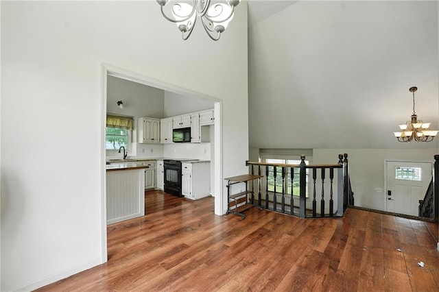 906 N Cedarcrest Dr, Olathe, KS 66061 - stairway with a chandelier, wood finished floors, and high vaulted ceiling
