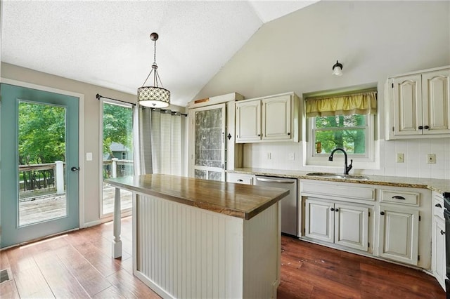 906 N Cedarcrest Dr, Olathe, KS 66061 - kitchen with dishwasher, lofted ceiling, dark wood-type flooring, light stone counters, and tasteful backsplash