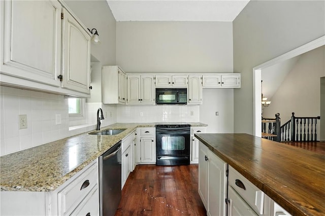 906 N Cedarcrest Dr, Olathe, KS 66061 - kitchen featuring black appliances, dark stone counters, a chandelier, and white cabinetry