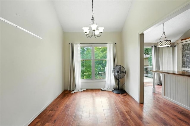 906 N Cedarcrest Dr, Olathe, KS 66061 - unfurnished dining area featuring lofted ceiling, a chandelier, and hardwood / wood-style floors