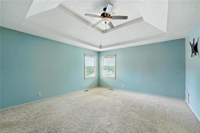 906 N Cedarcrest Dr, Olathe, KS 66061 - carpeted spare room featuring a raised ceiling, a textured ceiling, and a ceiling fan