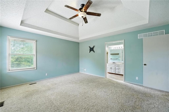 906 N Cedarcrest Dr, Olathe, KS 66061 - spare room with a raised ceiling, a ceiling fan, carpet floors, and a textured ceiling