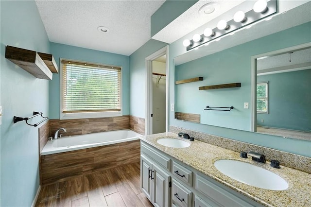 906 N Cedarcrest Dr, Olathe, KS 66061 - full bathroom with plenty of natural light, a bath, double vanity, and a textured ceiling