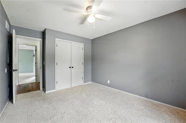 906 N Cedarcrest Dr, Olathe, KS 66061 - unfurnished bedroom featuring carpet floors, a closet, ceiling fan, and a textured ceiling