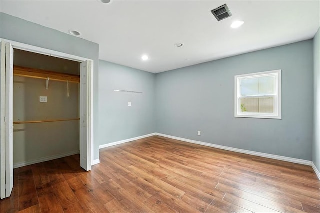 906 N Cedarcrest Dr, Olathe, KS 66061 - unfurnished bedroom featuring wood finished floors, a closet, and recessed lighting