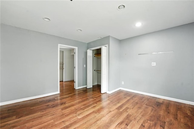 906 N Cedarcrest Dr, Olathe, KS 66061 - unfurnished bedroom featuring wood finished floors, recessed lighting, and a closet