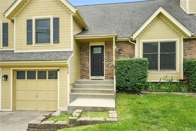 906 N Cedarcrest Dr, Olathe, KS 66061 - view of front of home with a garage, brick siding, a front yard, a shingled roof, and concrete driveway