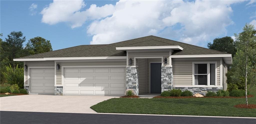 view of front of property with stone siding, a front lawn, an attached garage, and driveway