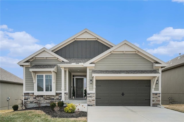 craftsman house featuring a shingled roof, board and batten siding, a garage, stone siding, and driveway