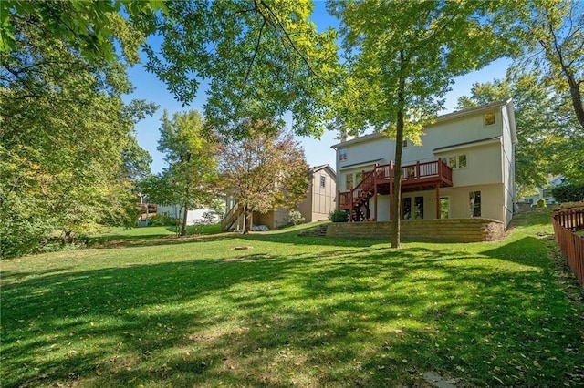 view of yard with stairs, fence, and a wooden deck