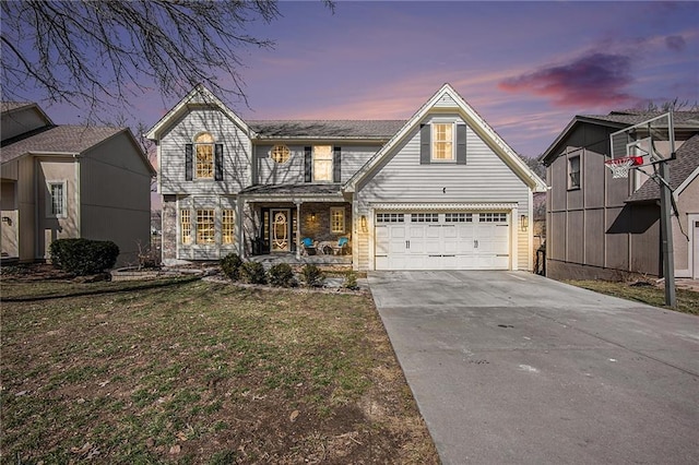 traditional home with concrete driveway and a front lawn