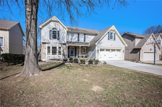 traditional-style house featuring a front yard, covered porch, and driveway