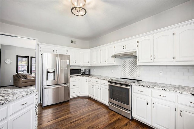 kitchen with white cabinetry, under cabinet range hood, visible vents, and appliances with stainless steel finishes