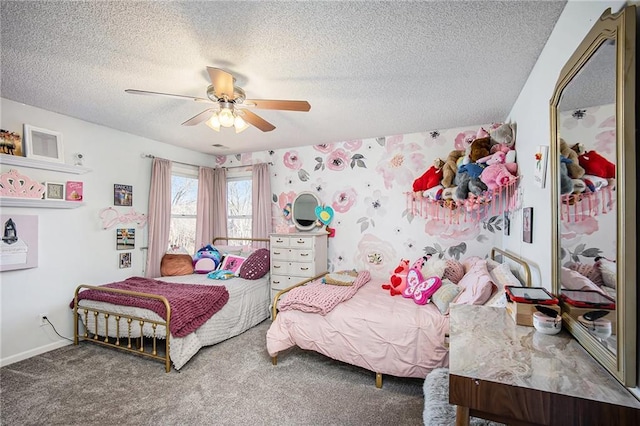 bedroom with ceiling fan, carpet flooring, baseboards, and a textured ceiling