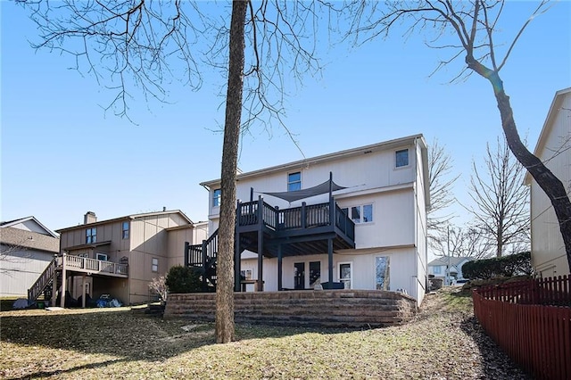 rear view of house featuring a deck and stairway