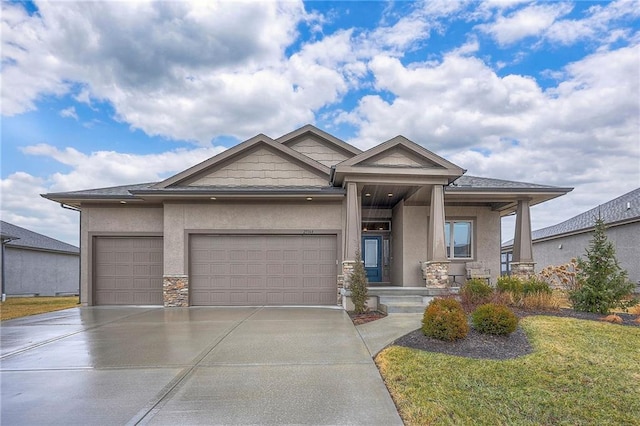 view of front of property featuring a garage, covered porch, driveway, stone siding, and stucco siding