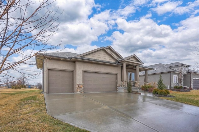 view of front facade featuring a garage, driveway, stone siding, a front lawn, and stucco siding