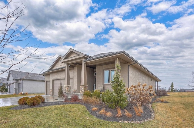 view of front of property featuring an attached garage, concrete driveway, a front yard, and stucco siding