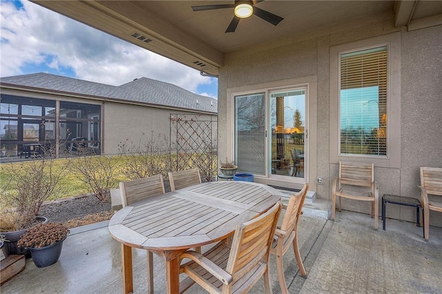 view of patio featuring visible vents, outdoor dining area, and a ceiling fan