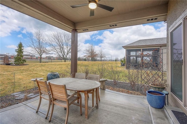 view of patio / terrace featuring visible vents, outdoor dining space, and a ceiling fan