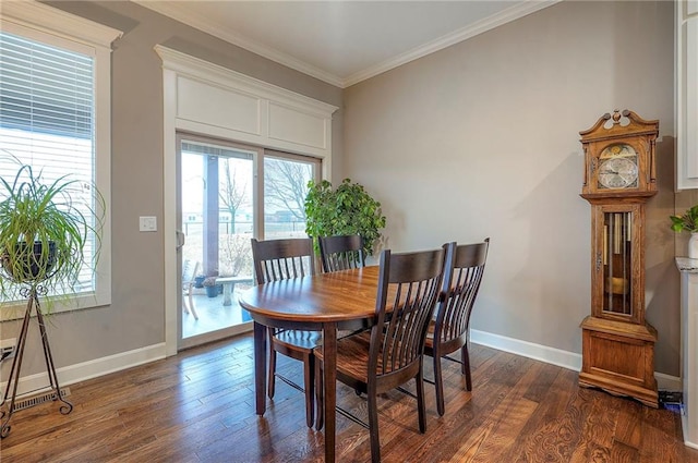 dining room with baseboards, dark wood-style flooring, and crown molding