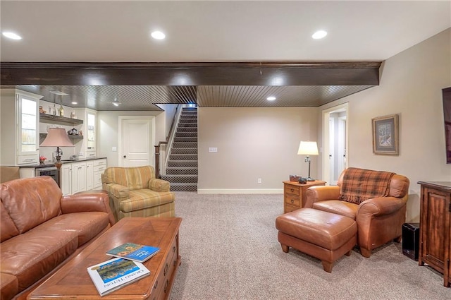 living area featuring recessed lighting, light colored carpet, baseboards, stairs, and beamed ceiling