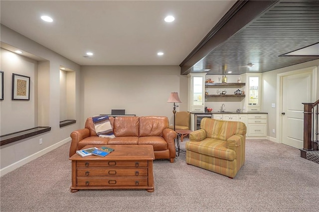 living area with wet bar, baseboards, light colored carpet, and recessed lighting