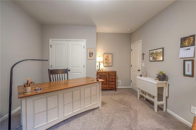 office area featuring light colored carpet and baseboards