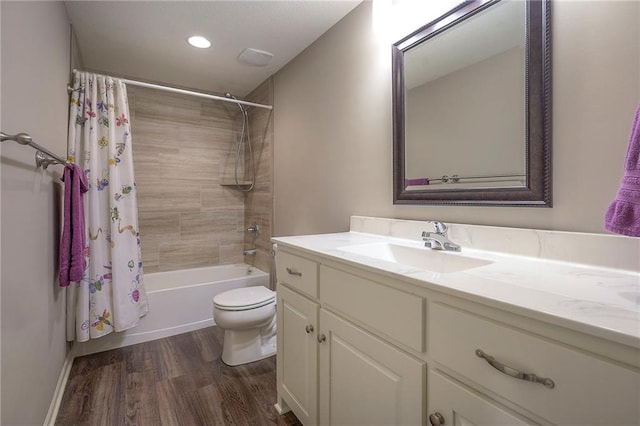 full bathroom with vanity, shower / bath combination with curtain, wood finished floors, and toilet