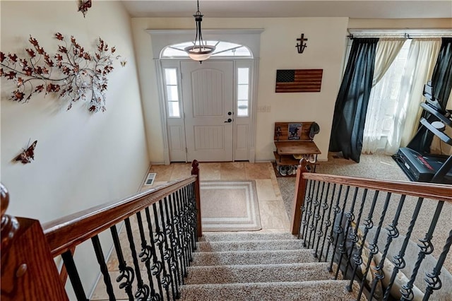 foyer featuring stairs and visible vents